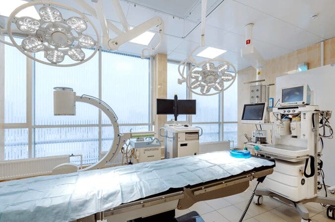 Modern operating room with medical equipment.
