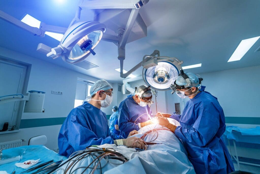 Surgeons performing surgery in operating room.