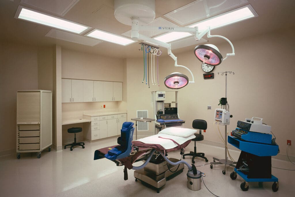Modern operating room with surgical equipment.