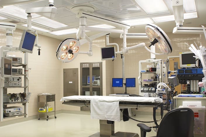 Modern hospital operating room with surgical equipment.