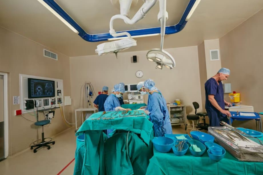 Surgeons performing an operation in a well-equipped operating room.